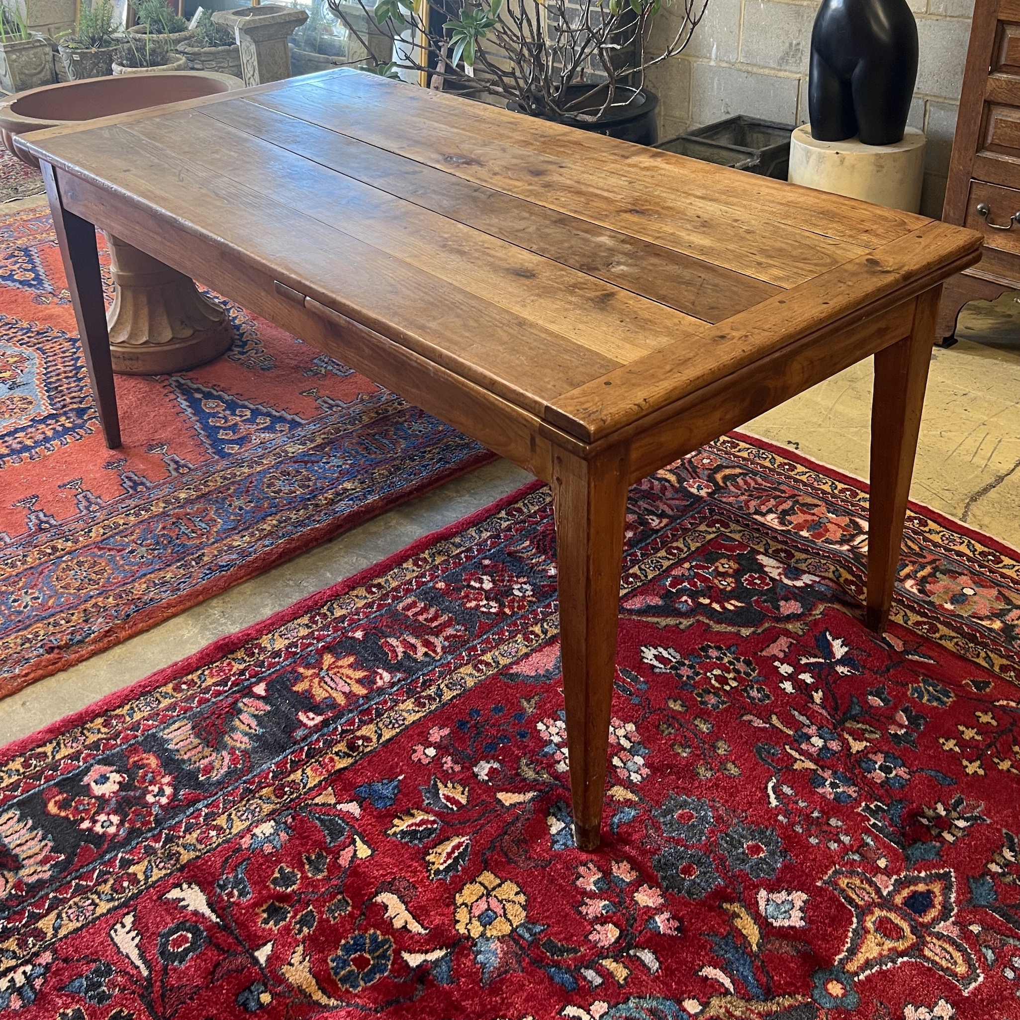 A 19th century French cherry farmhouse table with single extension on square tapered legs, width 166cm, (232cm extended) depth 82cm, height 73cm